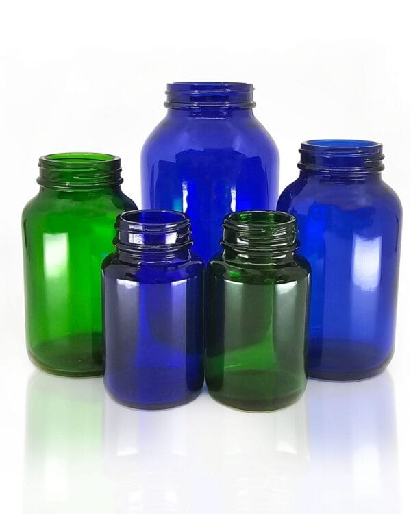 A photo of 5 different sized Origin pharma jars in blue and green glass