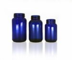 A photo of 3 blue pharma jars for packaging.