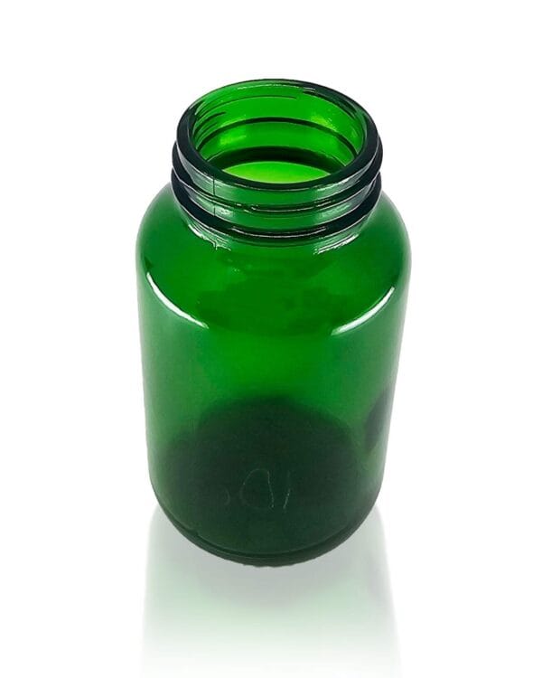 A close up photo of a 200ml green pharma glass jar from Origin Packaging